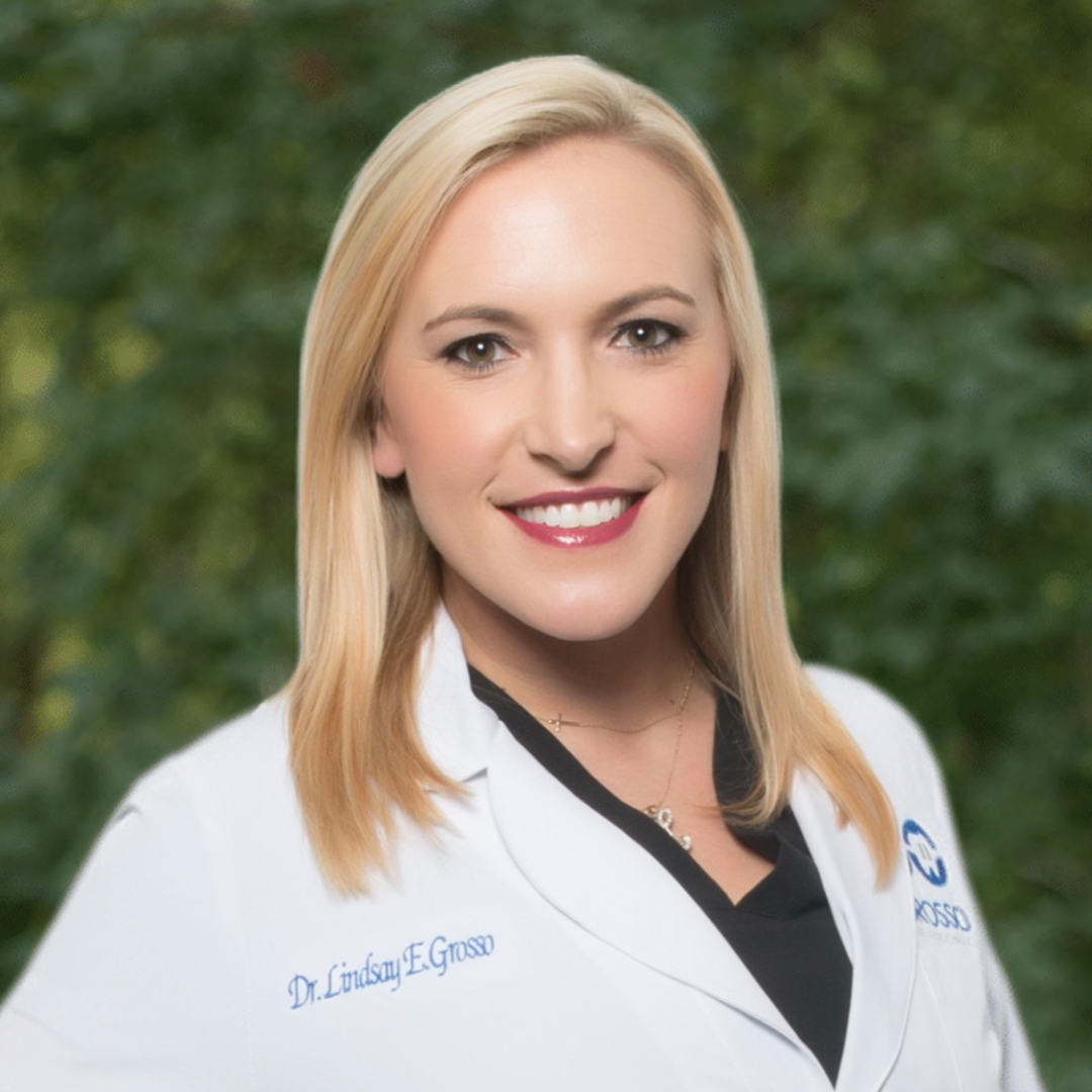 Female orthodontist in lab coat representing dental and orthodontic practice consulting and leadership development services