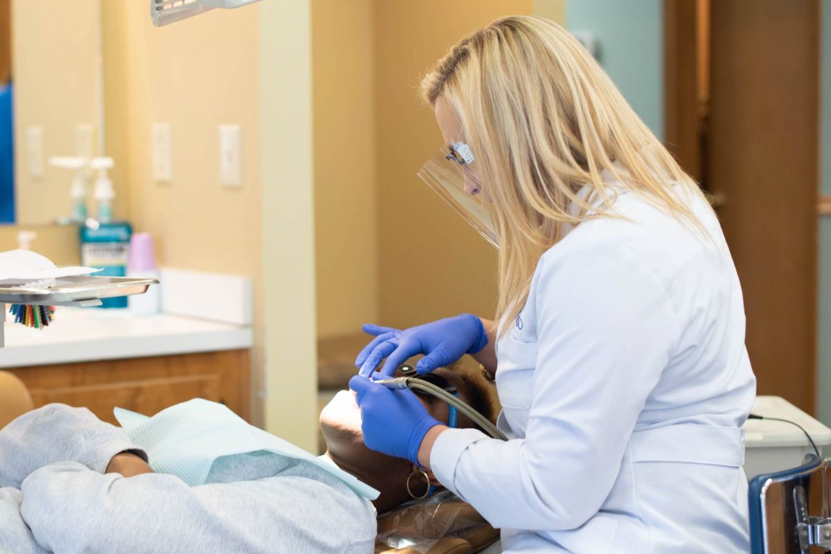 Orthodontic provider adjusting dental appliances for a child patient during treatment