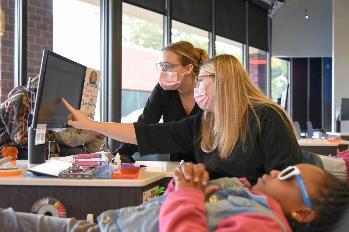 Orthodontic team members reviewing treatment details together during a pediatric appointment
